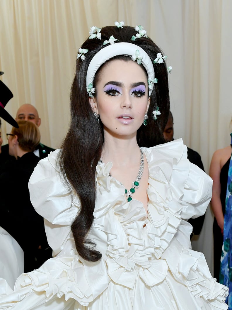 Lily Collins's Lilac Eye Shadow and Floral Hair Accessories at the Met Gala
