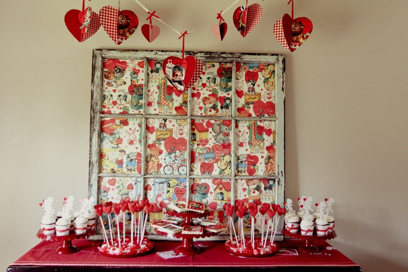 The focal point of the party was the sweets table, where cupcakes, cookies, and vintage posters set the theme of the soiree. 
Source: Jenny Cookies