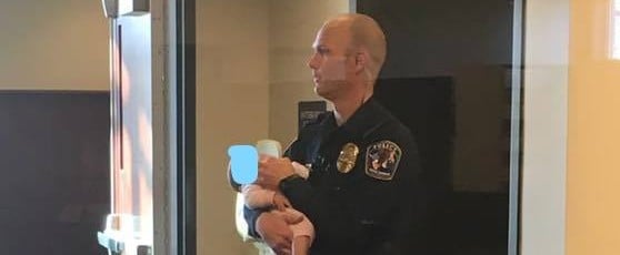 Police Officer Holds Baby For Mom at the Station