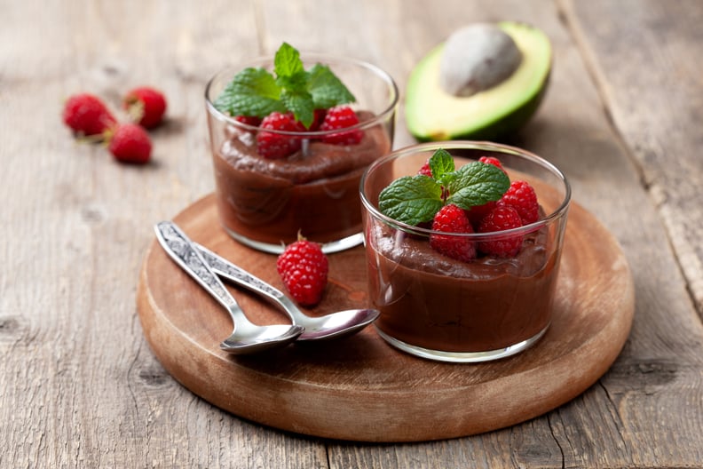 High-protein desserts in serving glasses on an old wooden background.