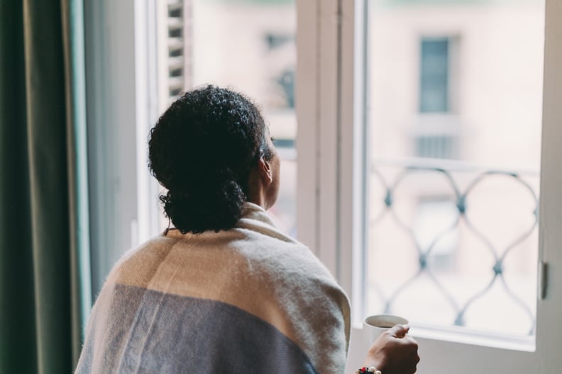 Woman in quarantine staying home, drinking coffee feeling depressed