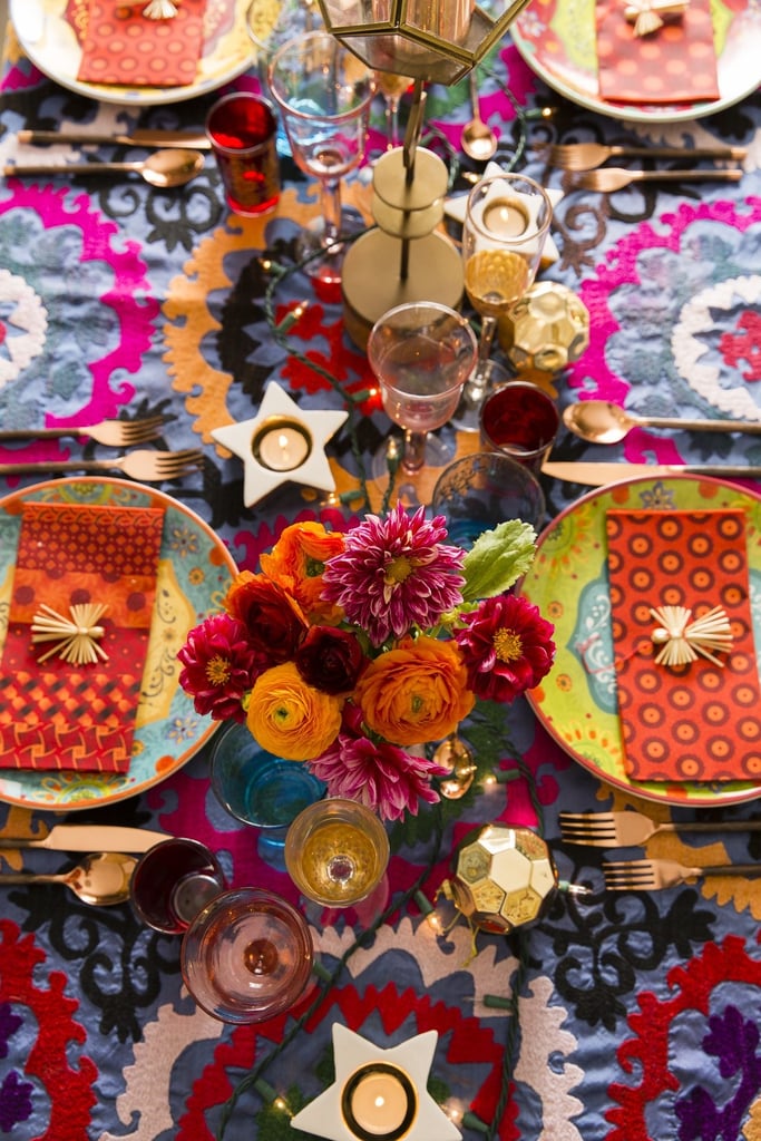 To create her stunning tabletop display, Justina mixed new pieces from Joss & Main with things she already had. She explained, "The motif on the plates remind me a bit of a suzani blanket, so I was inspired to use a vintage one that I bought in Istanbul as the tablecloth. From there I just started layering on the color, pattern, and sparkles!"