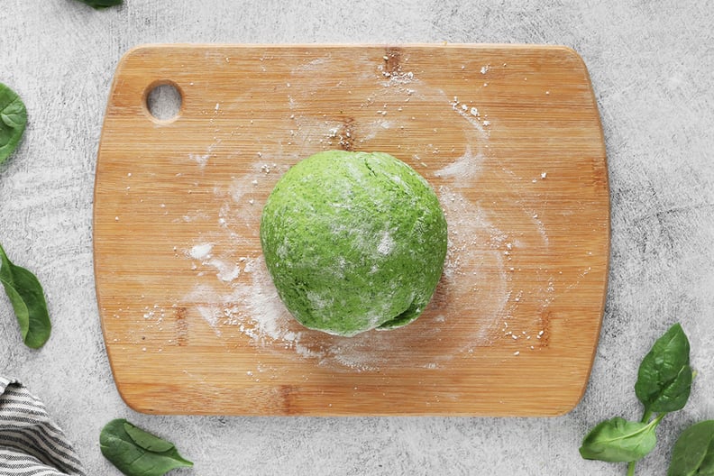 Spinach pasta dough on a floured cutting board