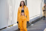 Julia Fox Sat Front Row at Diesel in a Yellow Leather Set and Latex Bandeau Top