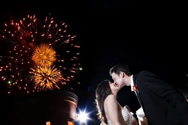 These lovebirds got affectionate during the fireworks show at their wedding.