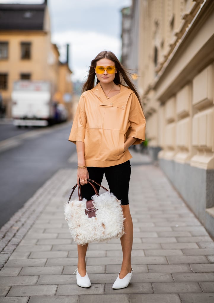 Give cycling shorts a minimalist vibe with understated pumps and a chic pullover.