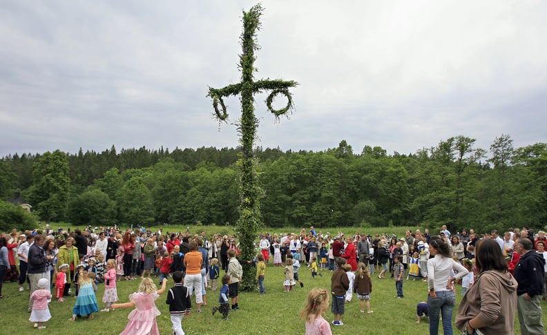 Tyreso, SWEDEN: Swedes dance as they celebrate the 
