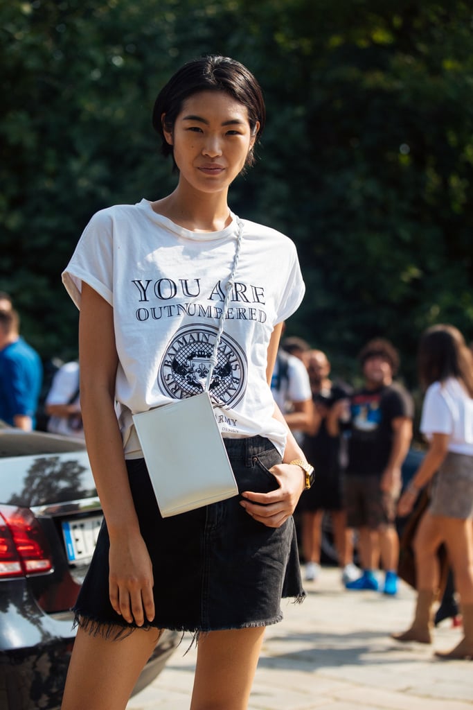 A cool cross-body bag dials up a graphic tee and denim mini.