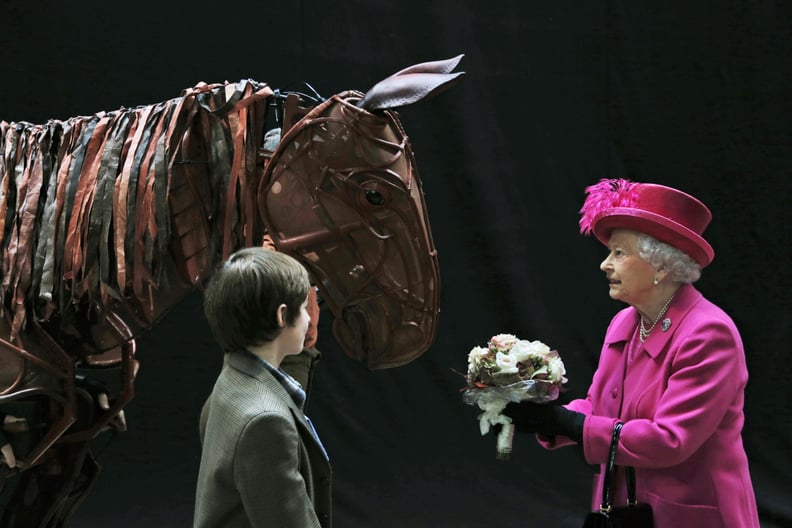 Queen Elizabeth II attends "War Horse" at the National Theatre in 2013.