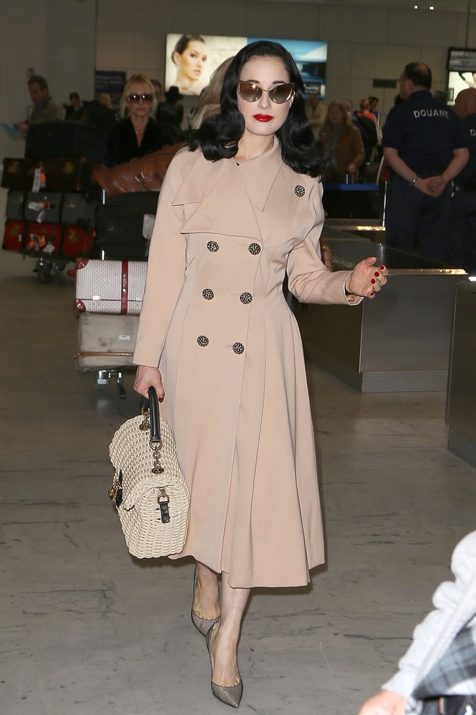 Dita Von Teese put her trench coat to good use at the airport. We imagine she's wearing something equally fabulous underneath, but you know, if not, we'd never be able to tell. Just finish the look with polished accessories and a bold red lip for a luxe travel style you might have sworn you saw on Mad Men.