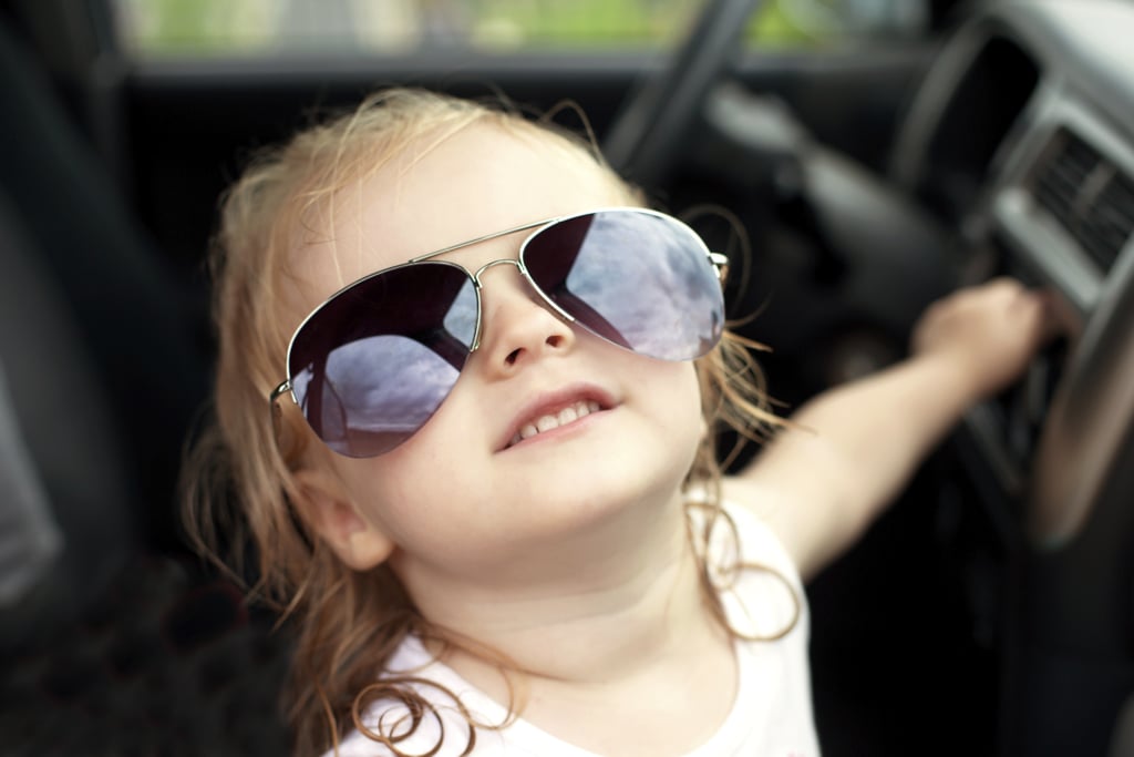 Child sitting in the front seat of a car