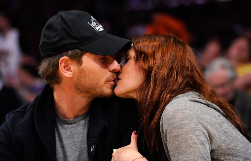 Drew Barrymore locked lips with Will Kopelman during a visit to LA's Staples Center in April 2011.