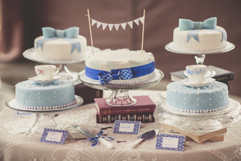 Although there's more than one cake on this dessert table, our eyes are on the bright blue bow-wrapped stunner in the middle. A delicate pearl edge and fun banner are all it takes to make this one swoon-worthy cake