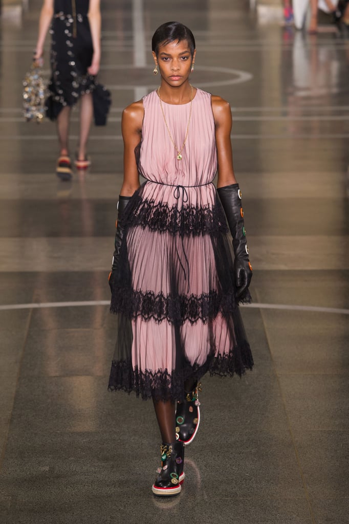 Picture her in this exact look, sans elbow-length leather gloves. We think this pink midi, complete with a gauzy overlay, would fit right into the elegant side of Michelle's wardrobe.
Christopher Kane Spring 2017.