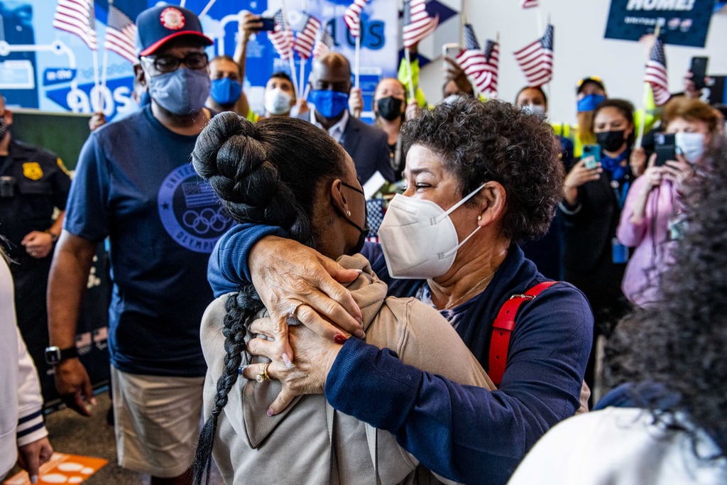 Simone Biles is home after competing in the Tokyo Olympics! On Aug. 5, the 24-year-old gymnast shared photos of her touching Houston reunion with her mom Nellie and dad Ron on Instagram. "Houston, I'm home," she captioned the post, thanking United Airlines for making it possible. "Thanks for making sure I didn't have to wait one more minute to see my family." Her parents weren't the only ones waiting, as Simone's return was met with a large crowd of friends, family, and fans alike. Even her dog Rambo got in on the action, patiently waiting for Simone's arrival. 
After a tough goodbye with her parents, who weren't able to be in Tokyo due to COVID-19 restrictions, Simone battled the "twisties" at the Olympics before ultimately taking home a silver and a bronze. "It was super emotional. It was hard for her family not to be there in Tokyo, so now that we can hug her and physically touch her, it's really nice," Simone's sister Adria told KPRC-TV. "Proud is an understatement. She is so amazing and I don't think people put their mental health in front like a priority. I'm so glad she can inspire people and tell them that it's OK."

    Related:

            
            
                                    
                            

            Stars React to Simone Biles&apos;s Olympic Win: "[It] Makes It So Easy to Call Her a Hero"