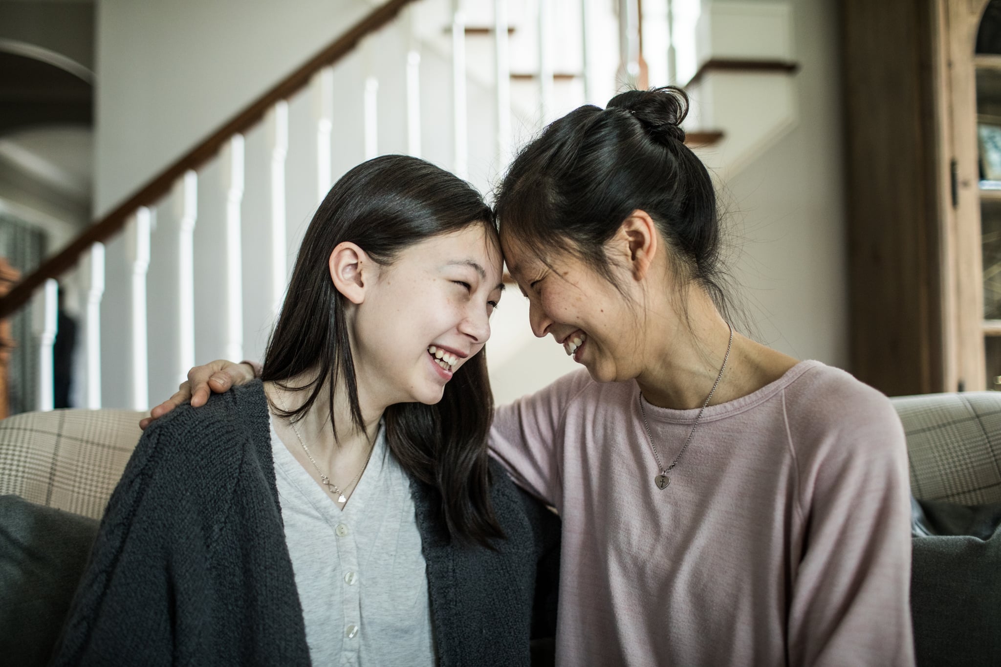 Mother and teenage daughter talking at home