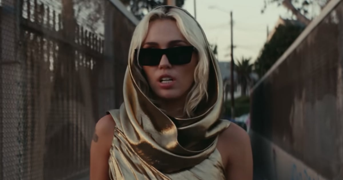 Miley Cyrus Wears Gold Cutout Dress in “Flowers” Music Video