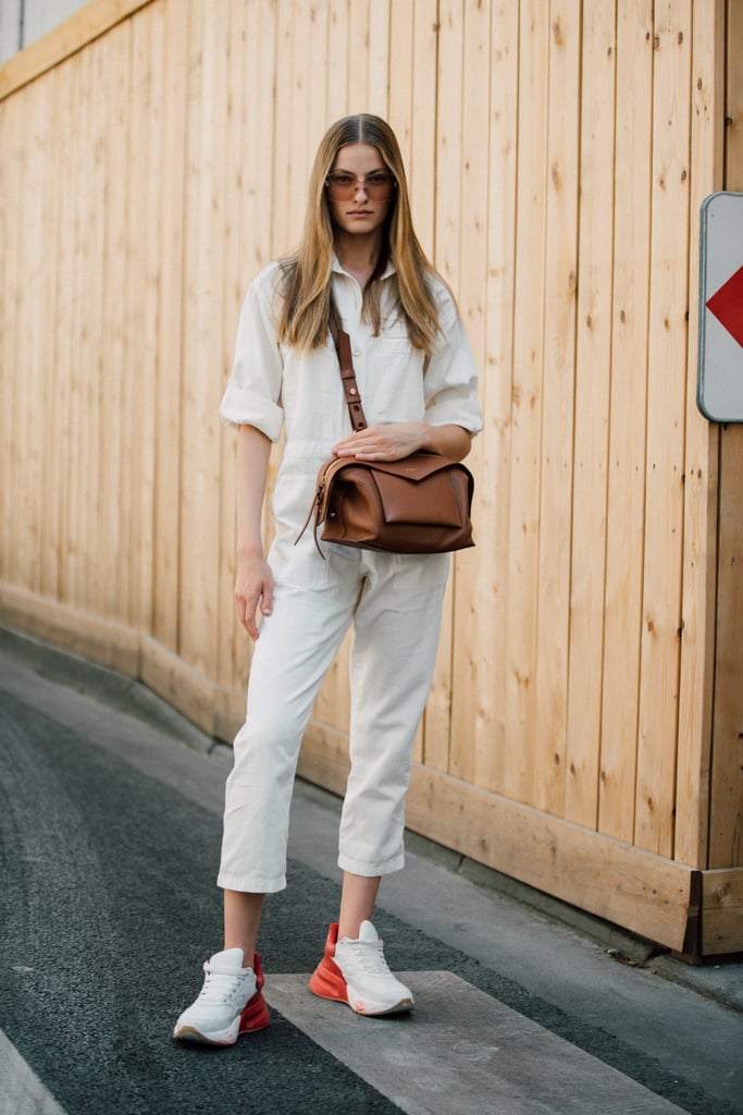 There's something downright chic about a pair of sleek sneakers and an understated jumpsuit.