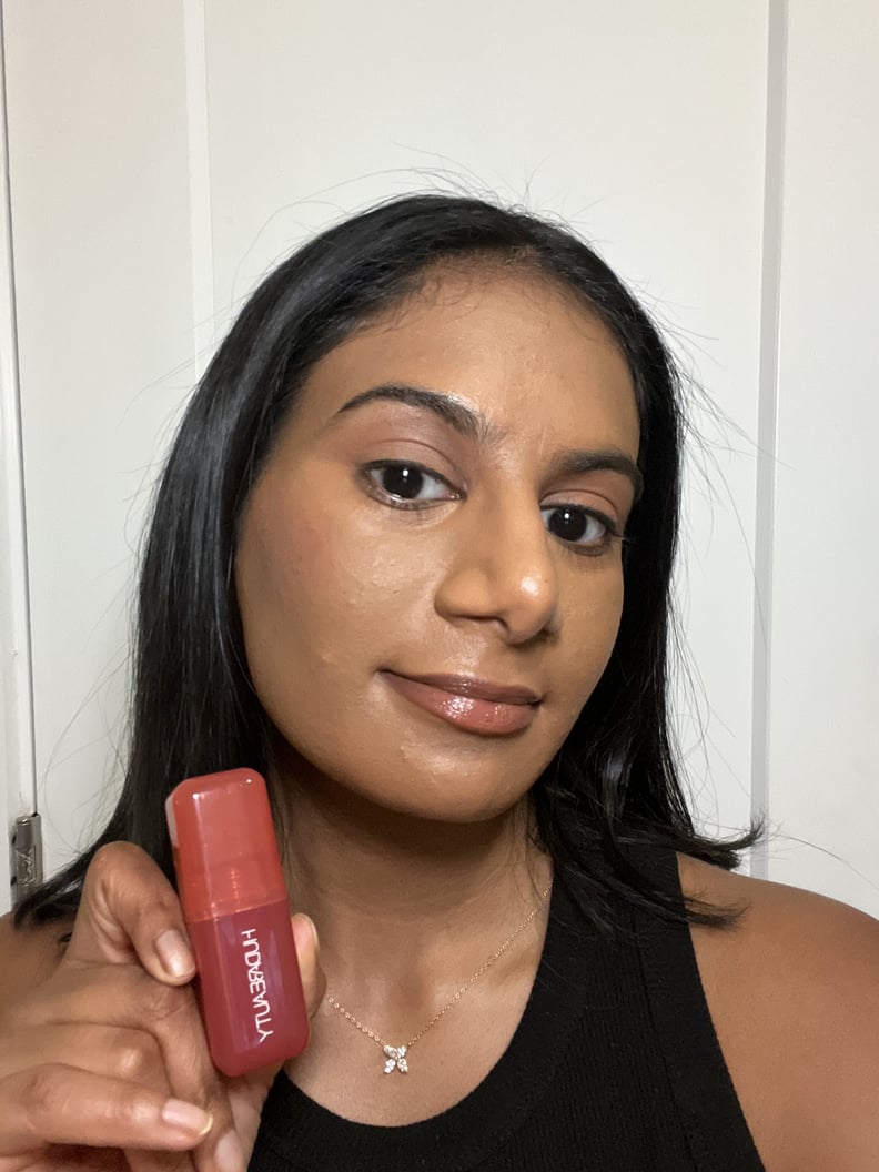 Woman wearing the Huda Beauty Blush Filter Soft Glow Liquid Blush in Watermelon Pop.