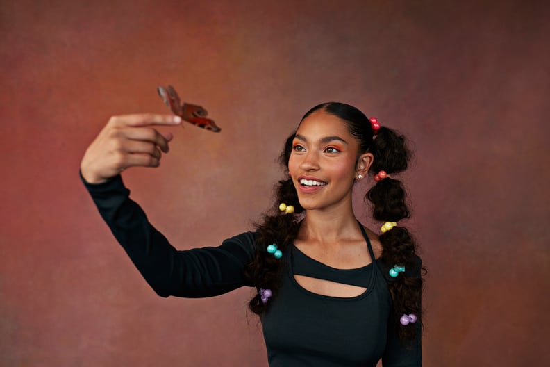 Teenage girl with butterfly on finger