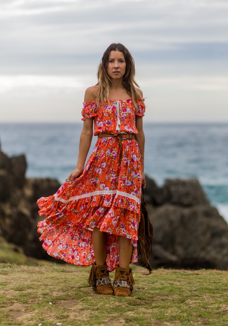 An off-the-shoulder maxi with boots