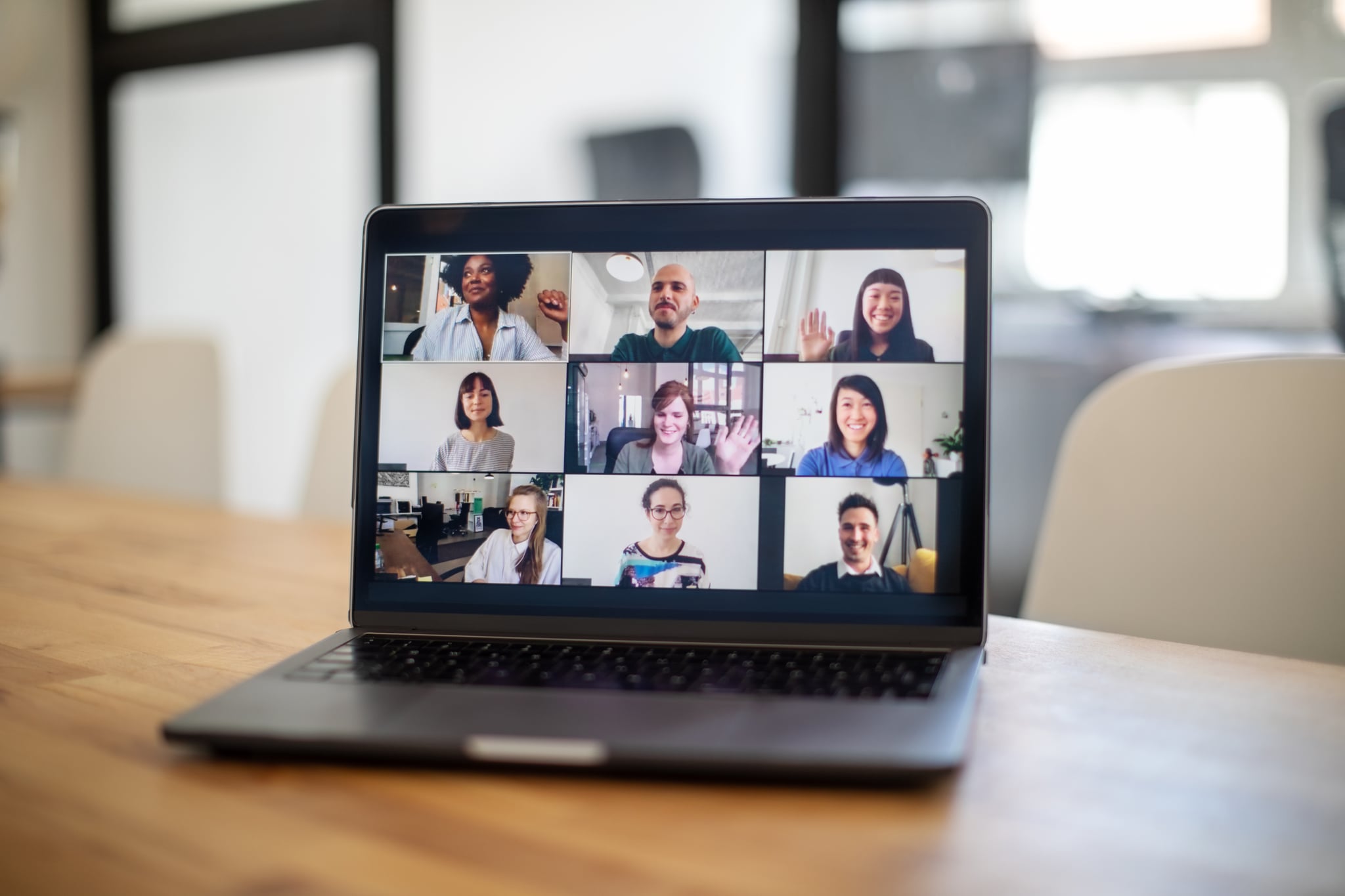 Group of business people seen on a laptop screen having an online meeting. Colleagues having a work meeting through a video call.