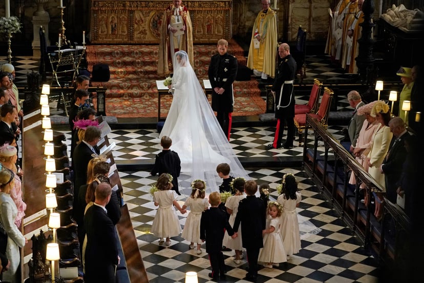 Britain's Prince Harry, Duke of Sussex (centre R) and US actress Meghan Markle (centre) stand at the altar with their bridsesmaids and page boys in St George's Chapel, Windsor Castle, in Windsor, on May 19, 2018 during their wedding ceremony with best man