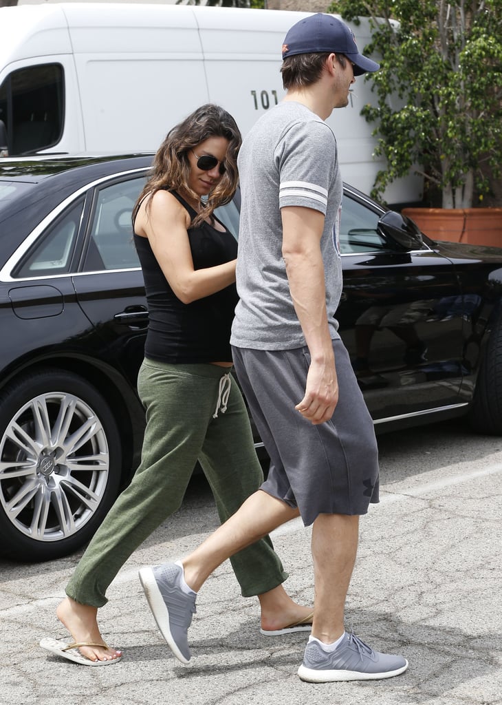 On Saturday, Mila Kunis held on to Ashton Kutcher's arm while the couple ran errands in LA.