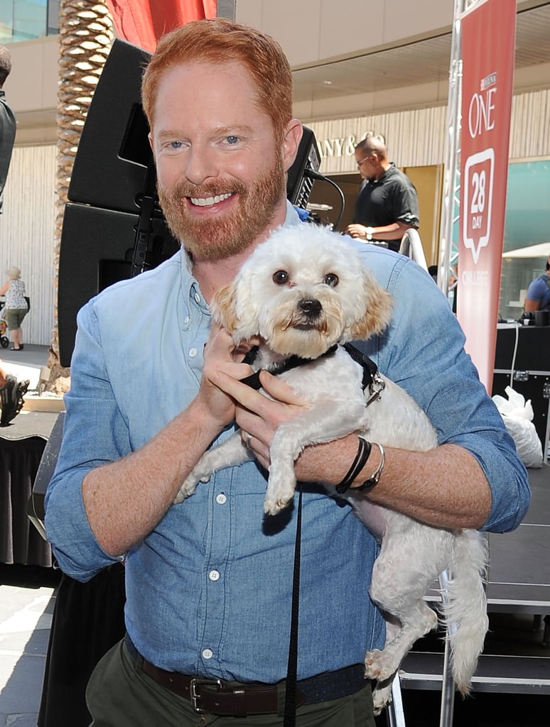 Jesse Tyler Ferguson cuddled up to a pup at an August 2015 Purina event in LA.