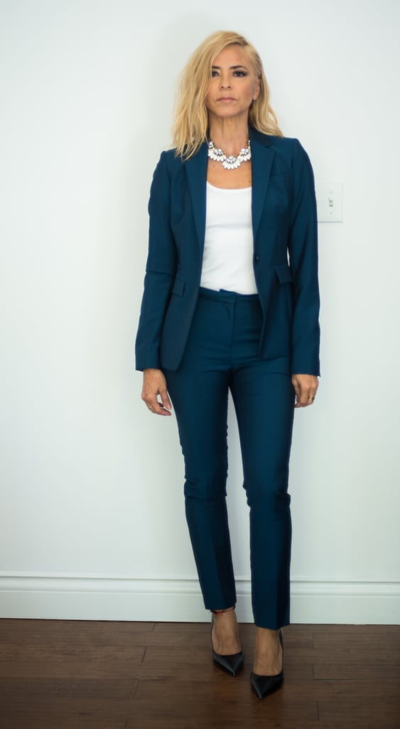 With a Blue Pantsuit, a White Necklace, and Black Pumps