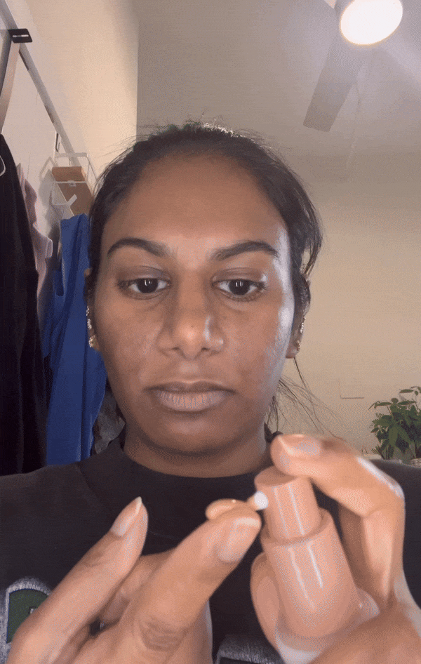 Woman applying the Live Tinted Hueguard Skin Tint SPF 50 Mineral Sunscreen on her skin.