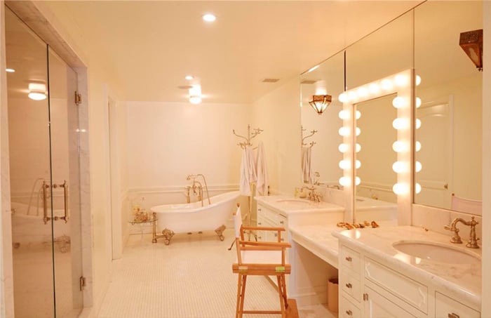 The marble-outfitted bathroom includes a luxe free-standing tub, large shower, and well-lit dressing area where Lauren can get ready for red carpet appearances.
