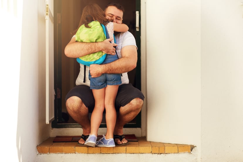 Shot of an adorable little girl hugging her father at the front door