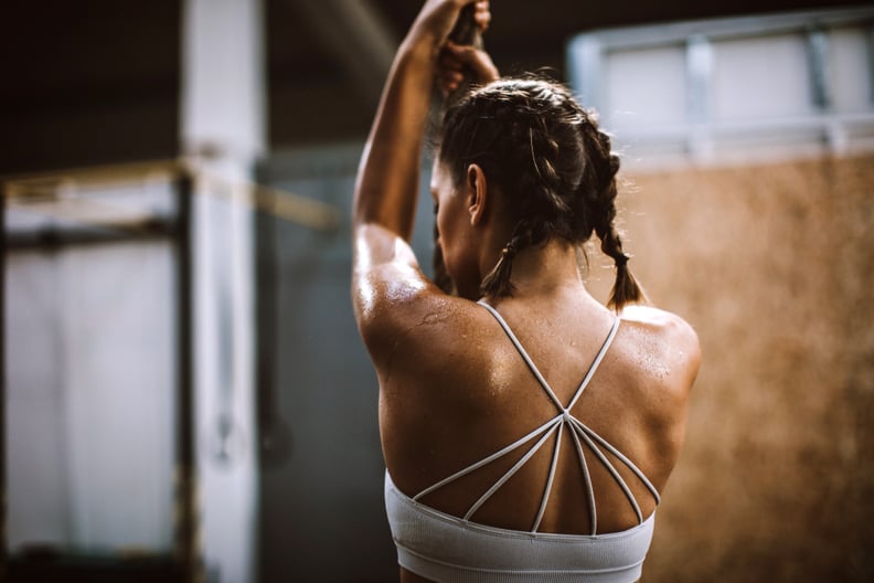 Athlete Woman Exercising Rope Climbing At Gym