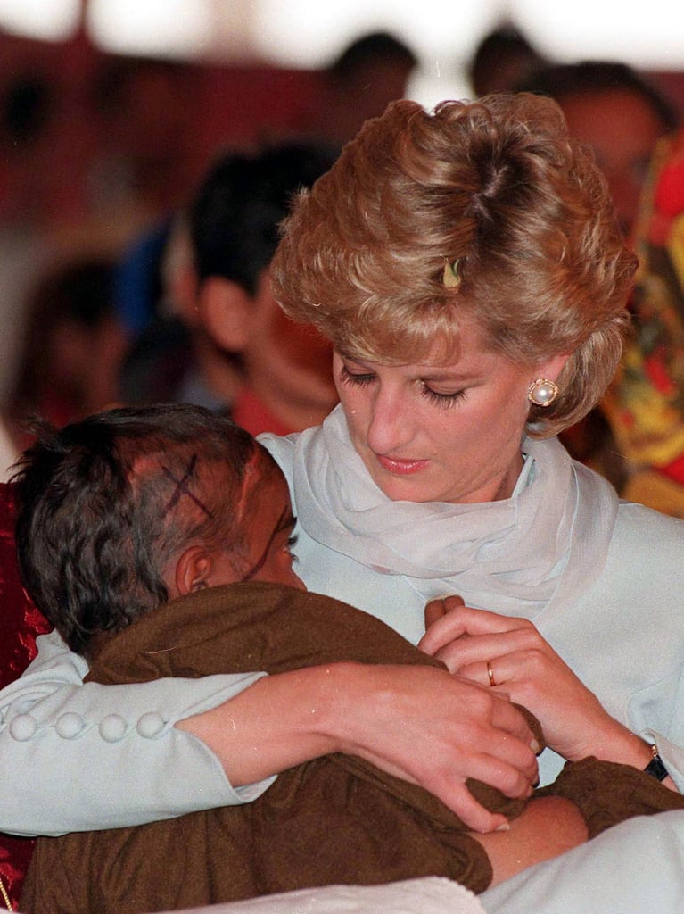 Diana cradled a sick child in her arms during her visit to Imran Khan's cancer hospital in Lahore, Pakistan, during April 1996.