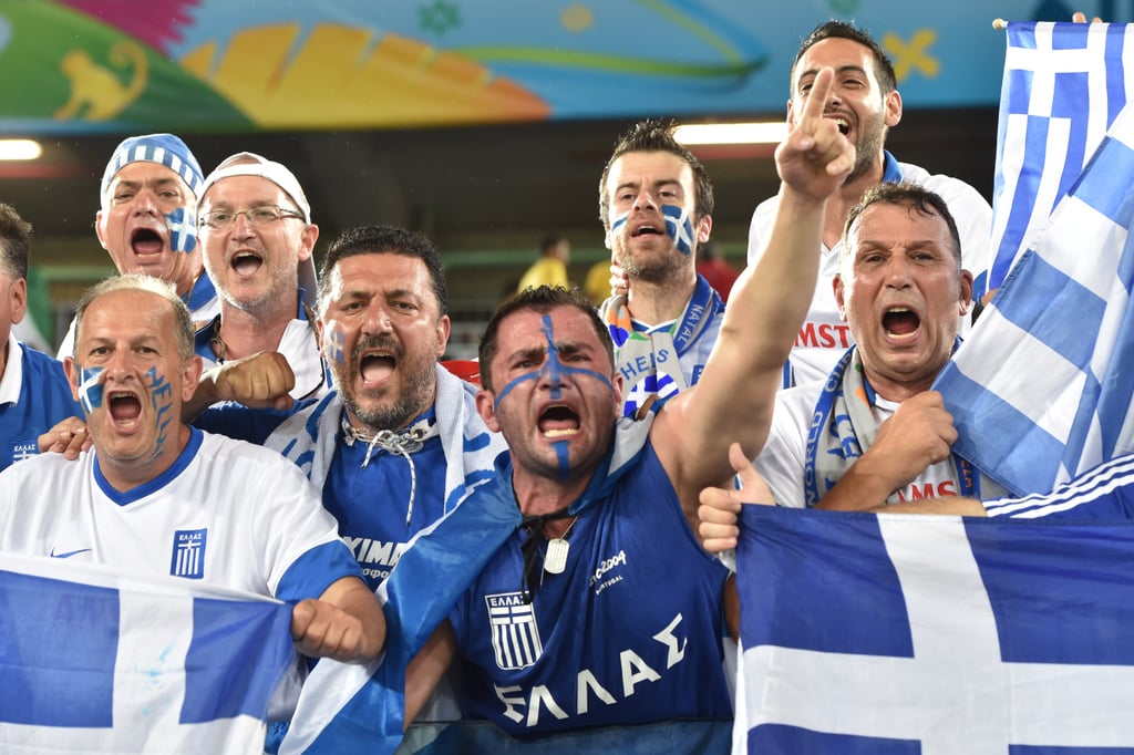 In Brazil, Greece fans held up flags and cheered ahead of the game against Japan.