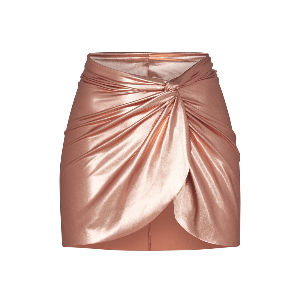 Skims Metallic Swim Sarong Mini Skirt in Champagne ($78)