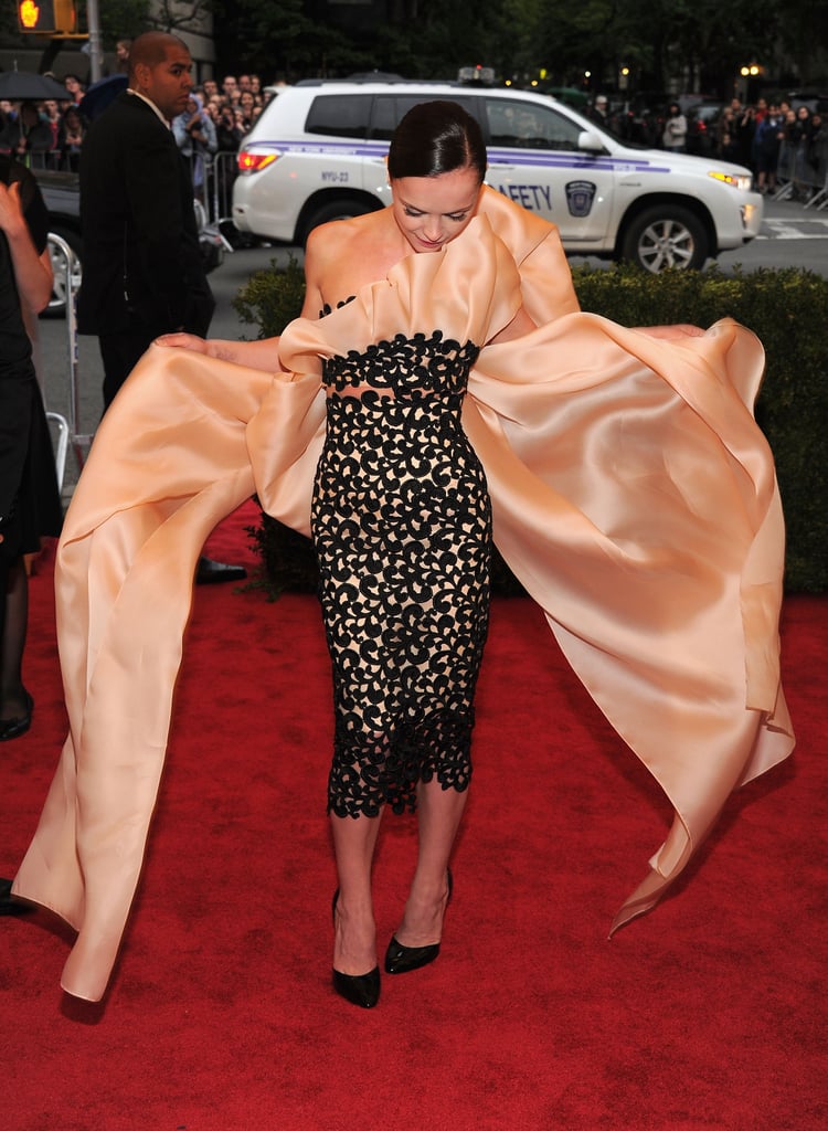 Christina Ricci stopped to wrangle the giant bow on her Thakoon creation that threatened to trip her up in 2012.