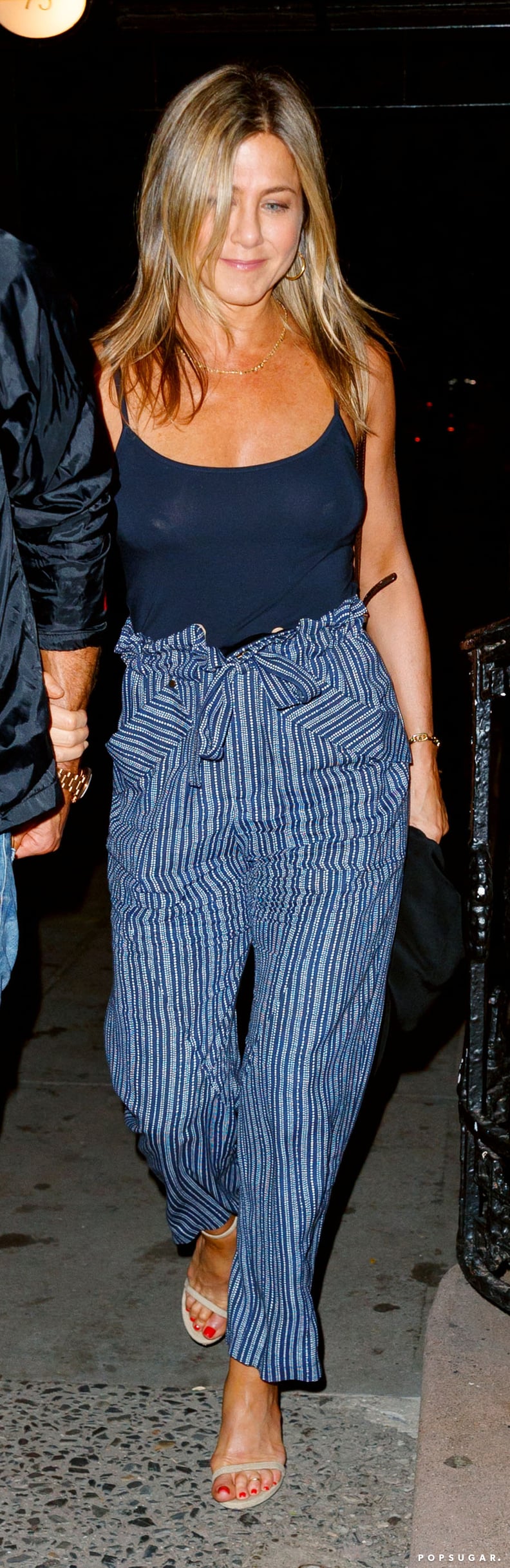 Jennifer Wore a Tank Top Tucked Into a Pair of Striped Paper-bag-Waist Trousers