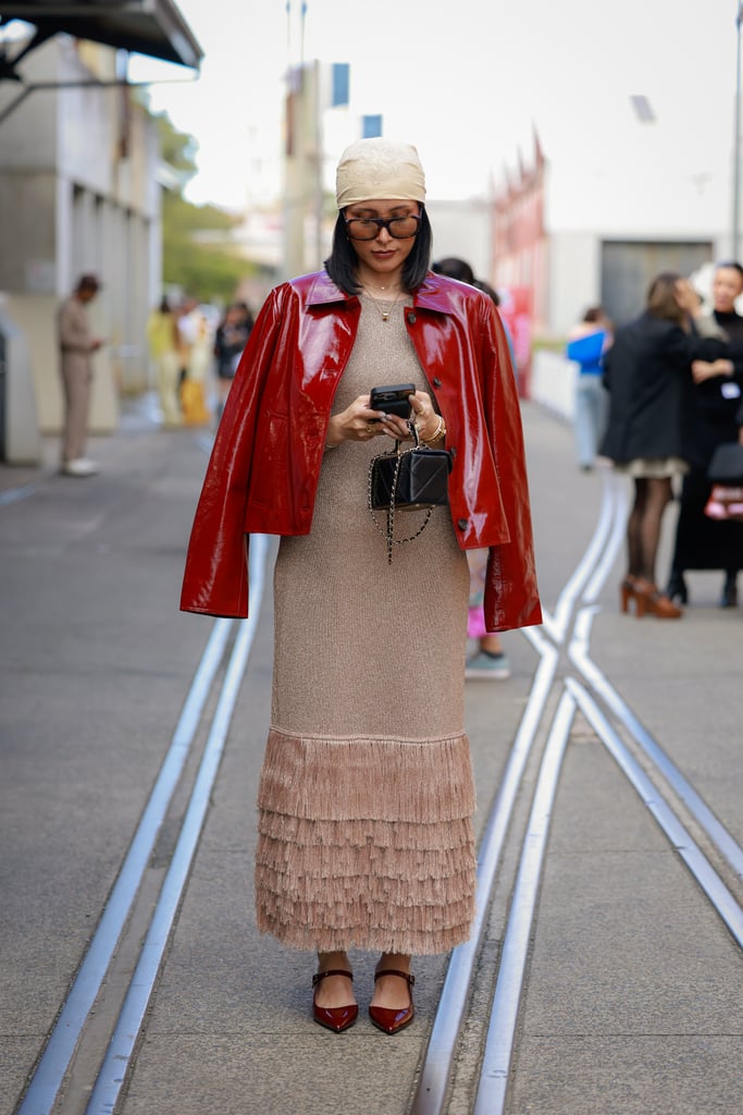 A red patent leather jacket added colour to an otherwise tonal outfit.