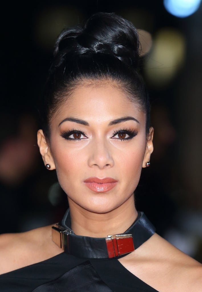 Just like you often see hair wrapped around the elastic of a ponytail, you can create a similar style with a topknot. Nicole Scherzinger accented hers with a braid.