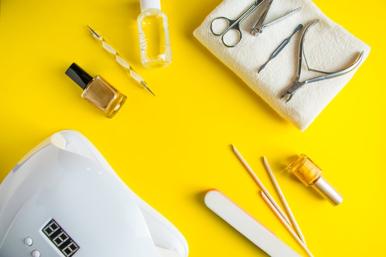 Set of tools for manicure and nail care on a yellow background.