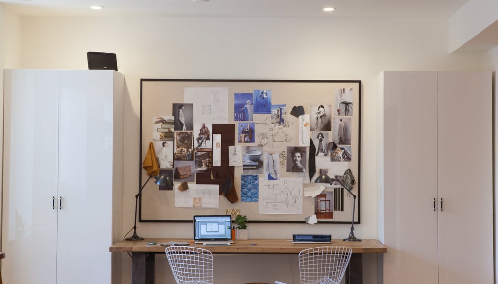 Behind the checkout counter,  Cuyana's seasonal inspiration board is sandwiched between two — wait for it — Ikea bookshelves that Lauren elevated by attaching elegant brass hardware.