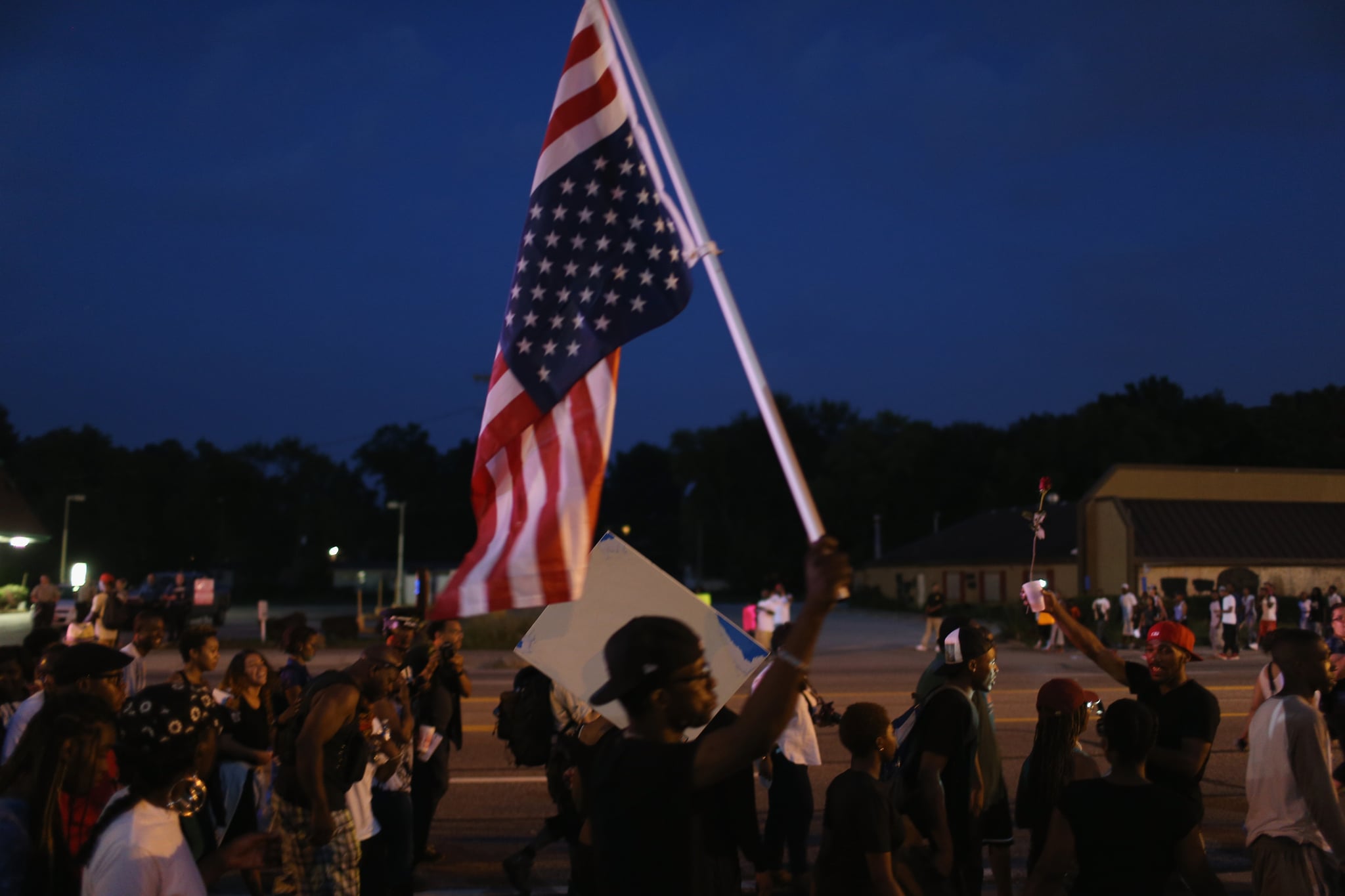 A Man Held An Upside Down American Flag During A Protest 21