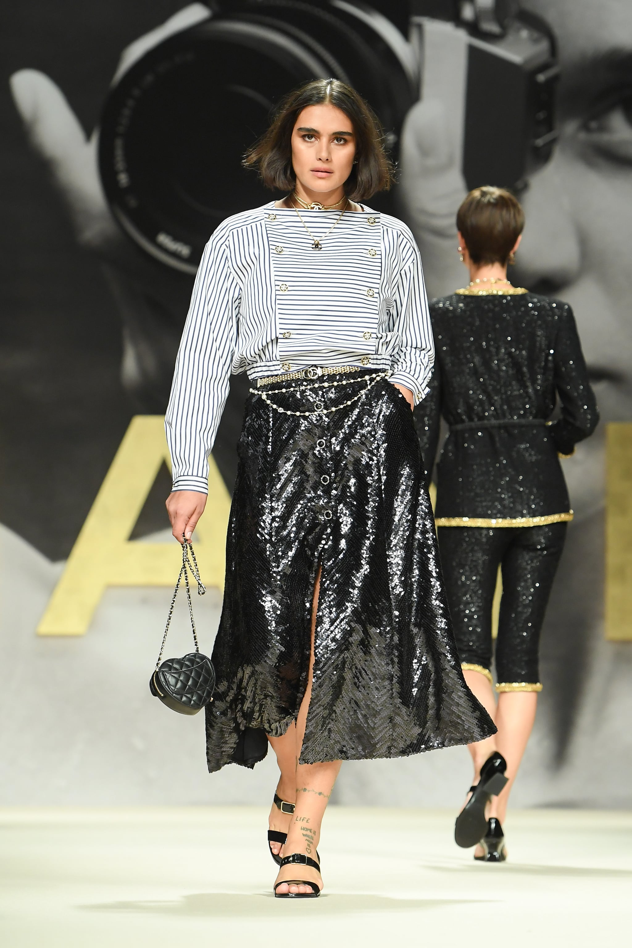 PARIS, FRANCE - OCTOBER 05: (EDITORIAL USE ONLY - For Non-Editorial use please seek approval from Fashion House) A model walks the runway during the Chanel Womenswear Spring/Summer 2022 show as part of Paris Fashion Week on October 05, 2021 in Paris, France. (Photo by Stephane Cardinale - Corbis/Corbis via Getty Images)