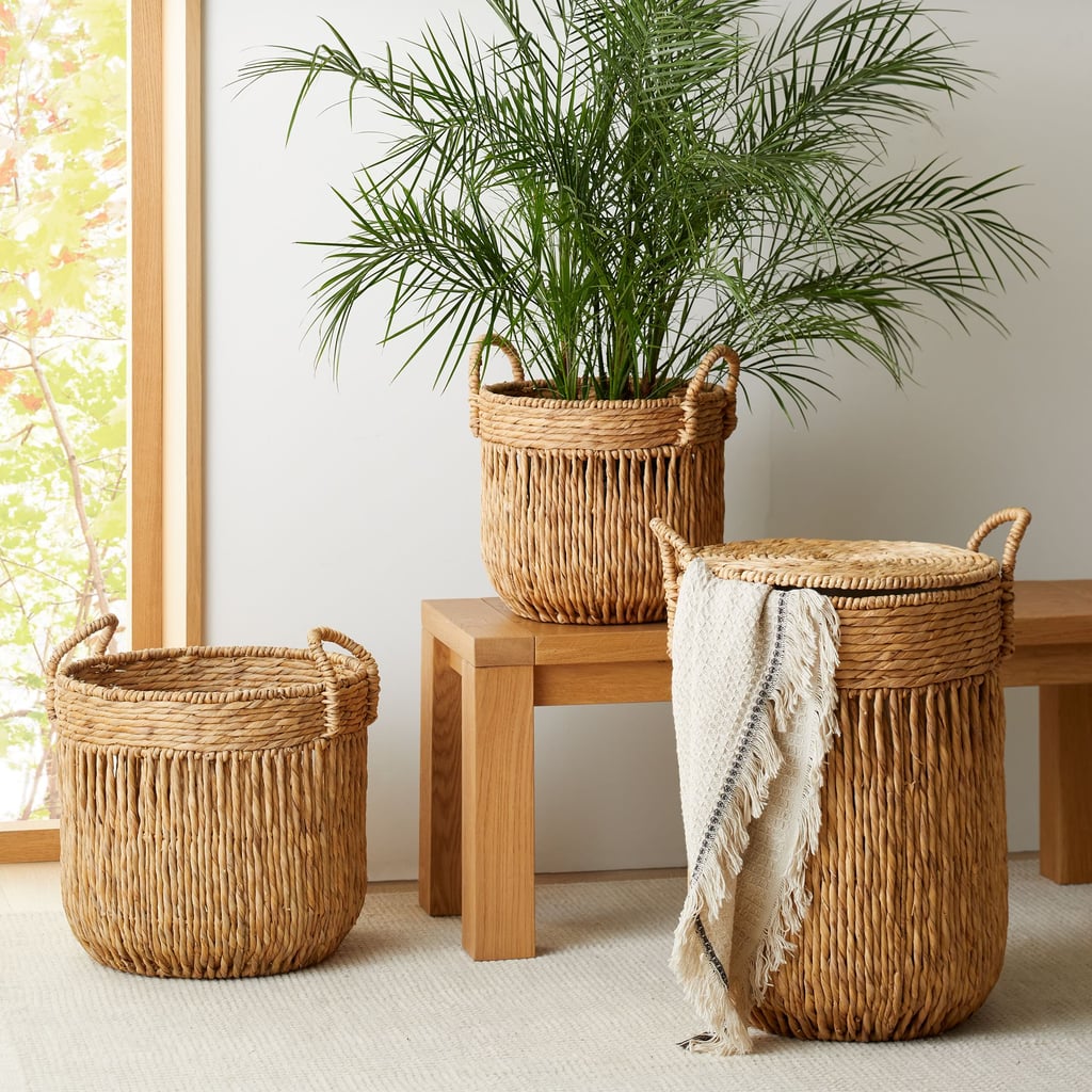 West Elm Vertical Lines Seagrass Basket ($85-$130)
Looking to add a boho flair to your decor? These seagrass baskets from West Elm are a stylish and sturdy option for your blanket storage needs. You can choose between two different options: one is shorter and wider, and another is a taller, hamper-style design with a lid. Both options have a vertical pattern that will give your space a more elongated look.