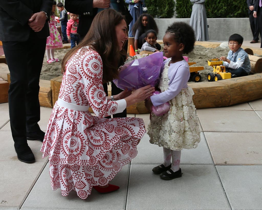 Awww! Kate knelt down to accept flowers from an adorable little girl during her visit to the the Immigrant Services Society of British Columbia during the royal tour of Canada in September 2016.