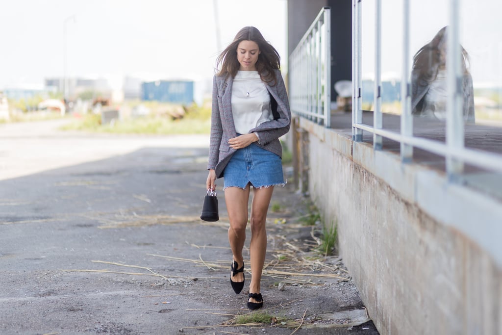 A frayed denim skirt feels smart with a classic blazer and feminine mules.