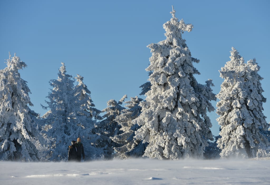 A couple took a snowy stroll on Feldberg, a tall mountain in central Germany.