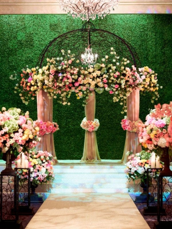 One of the popular settings for a wedding is in a garden because of the natural look of the flowers. Since this is typically sought after in Spring (aka when it rains), we like to work with our brides to bring the garden indoors. A recent wedding we worked on focused on a "secret garden" theme to really bring it all together. We turned the drab country club into a garden by including fresh flowers that weren't constructed into tall centerpieces, but rather deconstructed to look a little less formal. We also brought heavy greenery to the double doors outside so that guests knew the were entering the garden. Even the walls had flower arrangements on them.